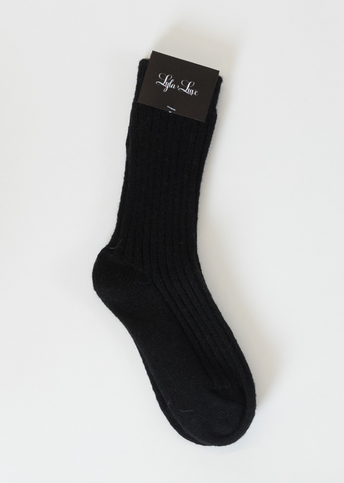 Lyla & Luxe Cotton Cashmere Socks- Black. Whether you're lounging at home or out and about in colder weather, these socks keep your feet feeling pampered and comfortable all day long. With their luxurious feel and versatile design, these socks are a must-have addition to any wardrobe, offering both style and indulgent comfort for every occasion.