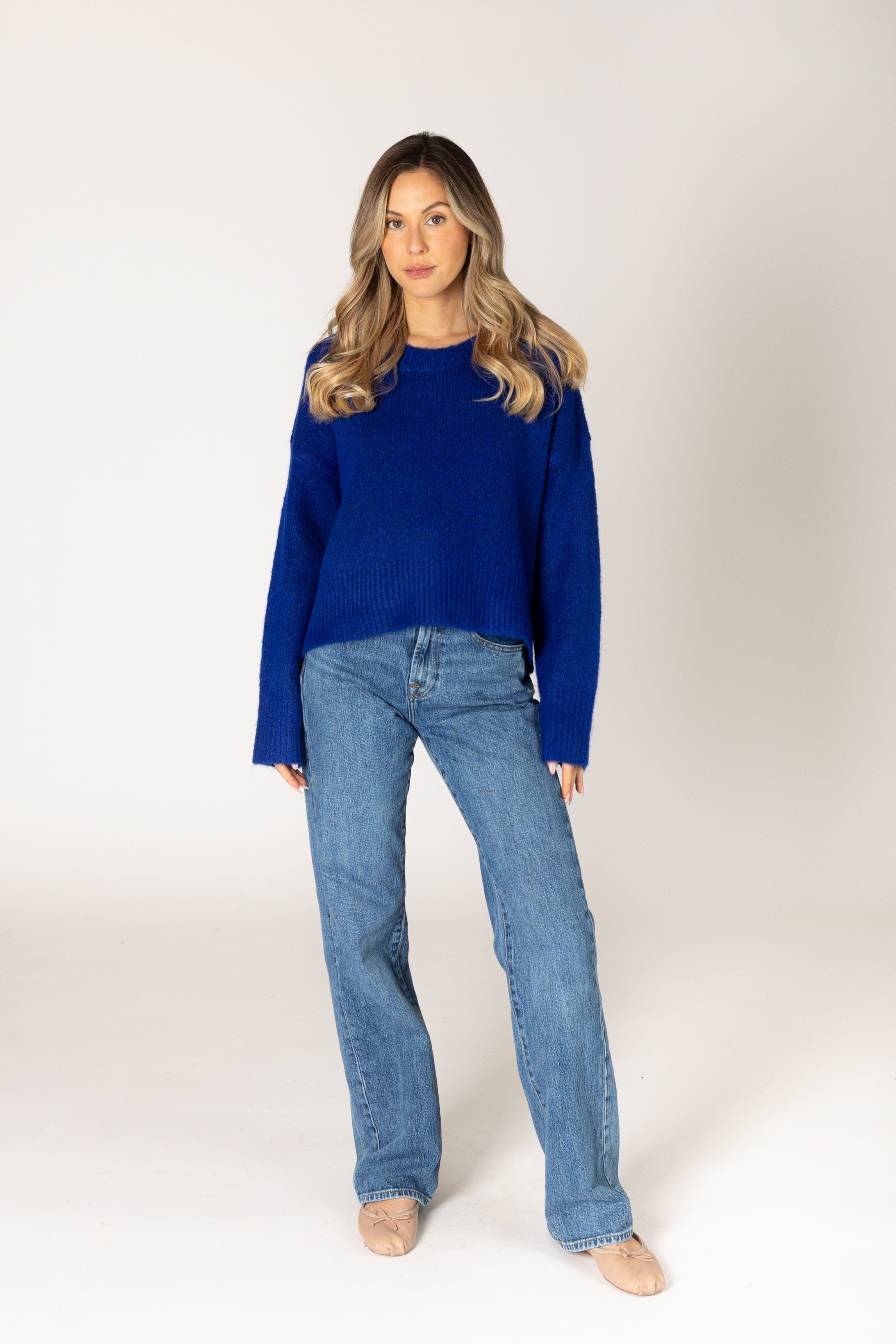 Classic crewneck sweater in a cobalt blue, featuring a simple silhouette with ribbed cuffs and hem.