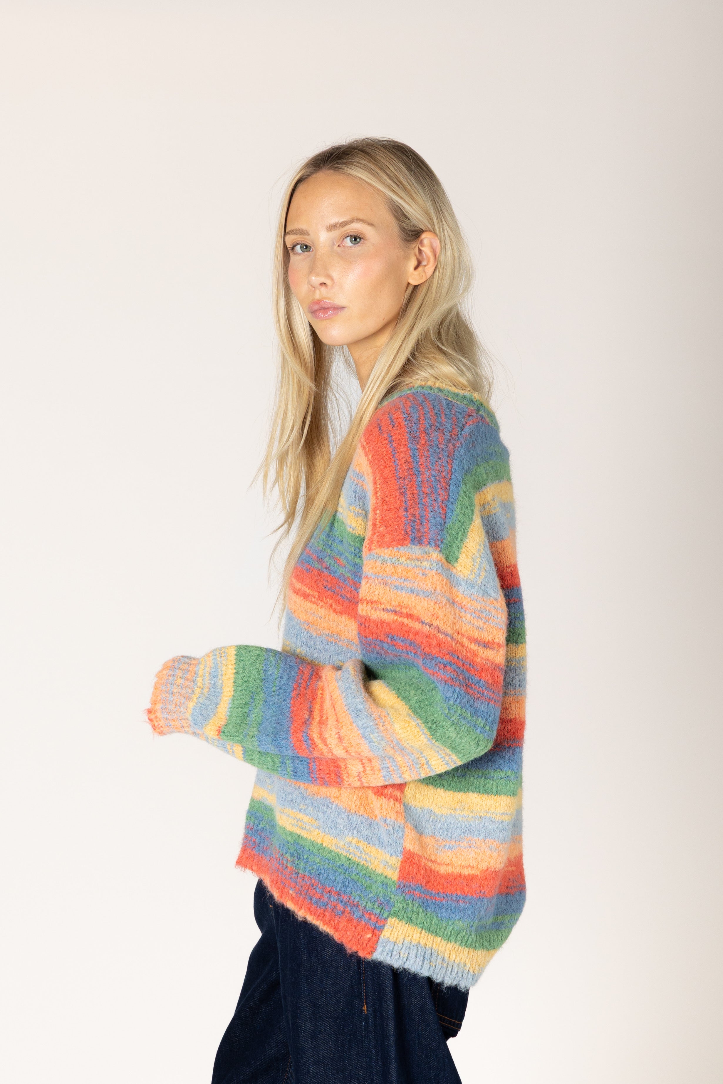 Multicolor striped fuzzy knit sweater featuring a relaxed fit, classic crew neckline, long sleeves, and ribbed cuffs and hem.

