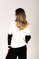 Black-and-white crewneck sweater featuring bold “LES ALPES” lettering across the front and a relaxed fit.
