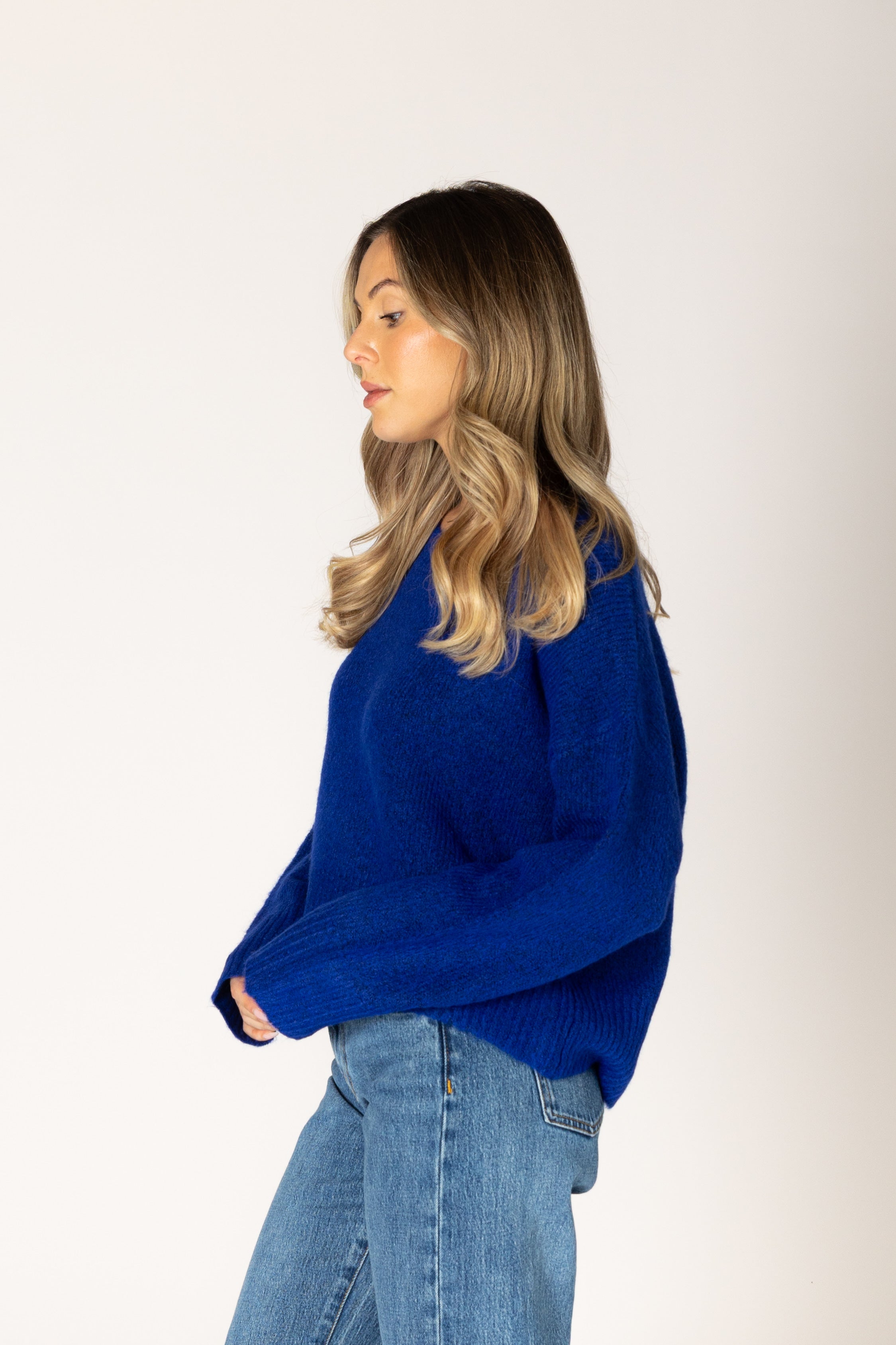 Classic crewneck sweater in a cobalt blue, featuring a simple silhouette with ribbed cuffs and hem.