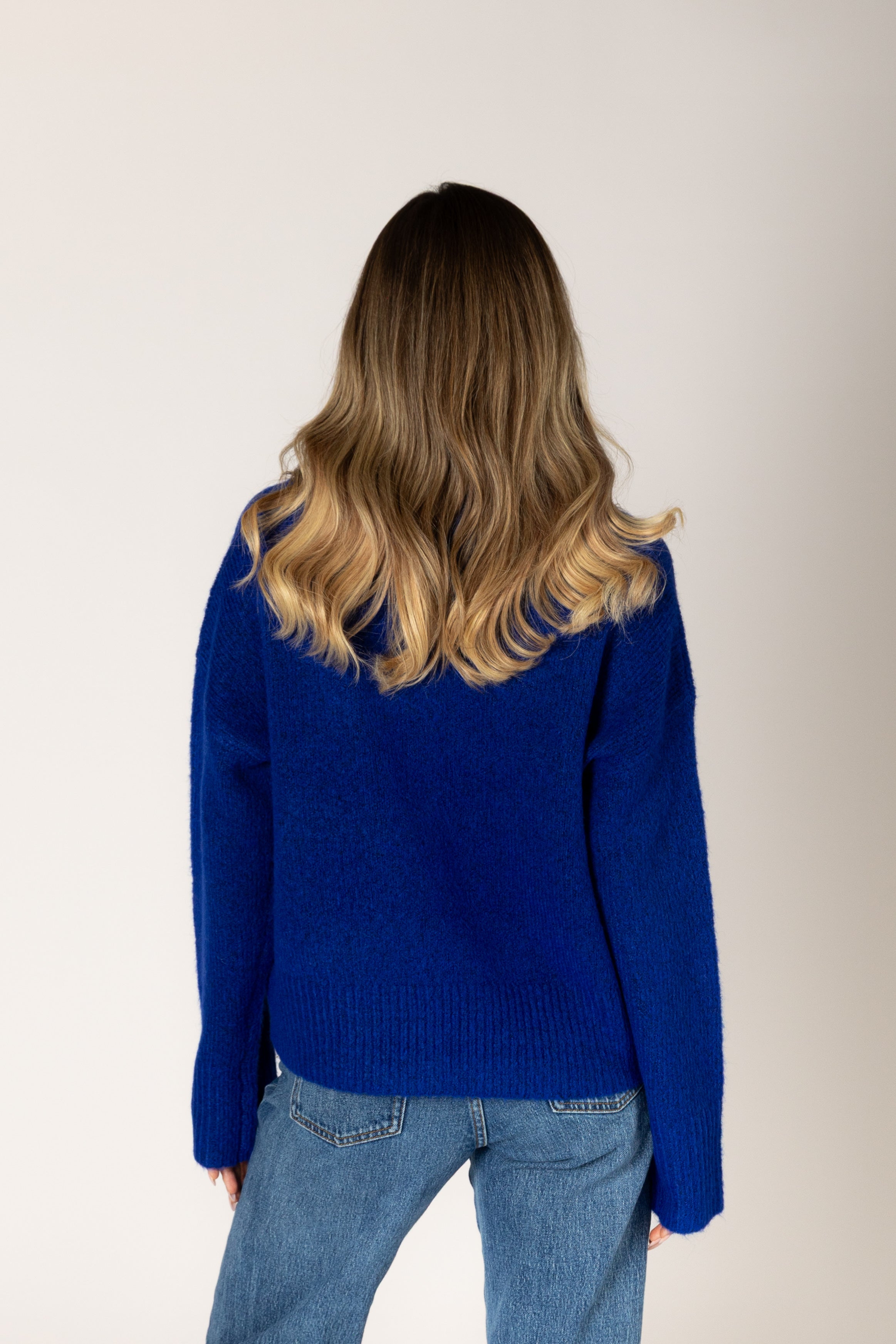 Classic crewneck sweater in a cobalt blue, featuring a simple silhouette with ribbed cuffs and hem.
