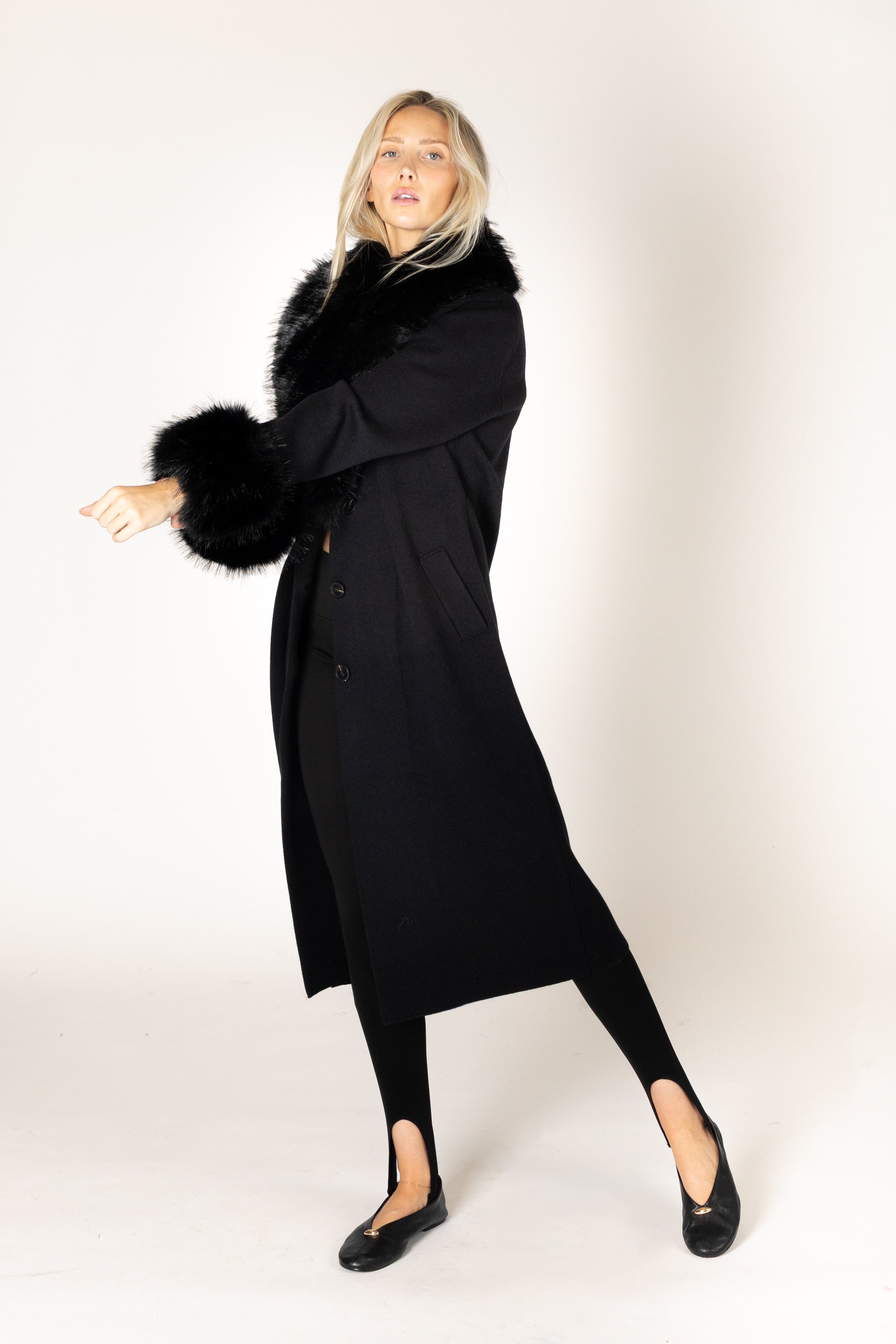 Make a statement this season with the elevated Vicki Fur Coat, designed with luxurious eco faux fur trim at the collar and cuffs for a touch of timeless glamour. Featuring a flattering longline silhouette, a classic notch collar, and a refined three-button closure, this sophisticated coat combines elegance with everyday wearability. Crafted to keep you warm while elevating any outfit, it's the perfect outerwear piece for both special occasions and everyday sophistication.

**Care:** Hand wash cold. Lay flat