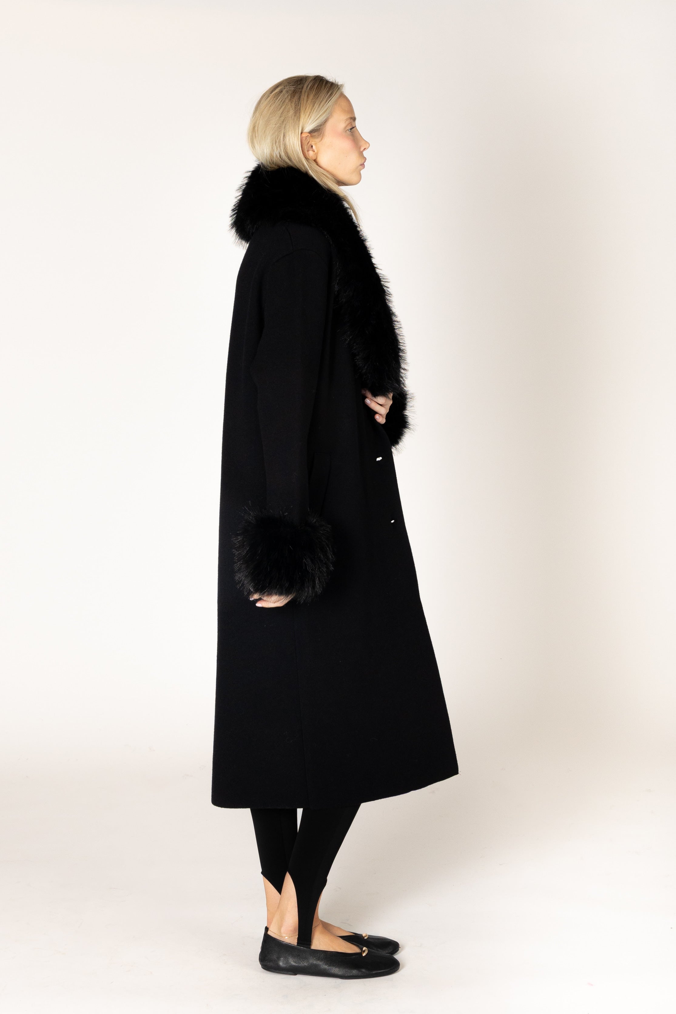 Make a statement this season with the elevated Vicki Fur Coat, designed with luxurious eco faux fur trim at the collar and cuffs for a touch of timeless glamour. Featuring a flattering longline silhouette, a classic notch collar, and a refined three-button closure, this sophisticated coat combines elegance with everyday wearability. Crafted to keep you warm while elevating any outfit, it's the perfect outerwear piece for both special occasions and everyday sophistication.

**Care:** Hand wash cold. Lay flat