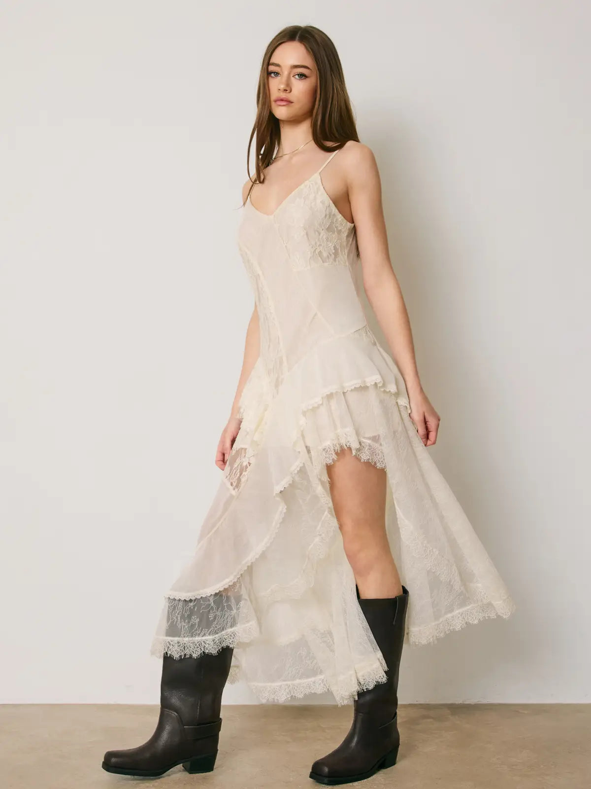 Marielle Lace Tiered Midi Dress featuring delicate floral lace, mixed lace panel detailing, cascading tiered ruffles, and an asymmetrical high-low hemline. Designed with a flattering V-neckline, adjustable spaghetti straps, a scoop back, and a romantic, flowy silhouette.
