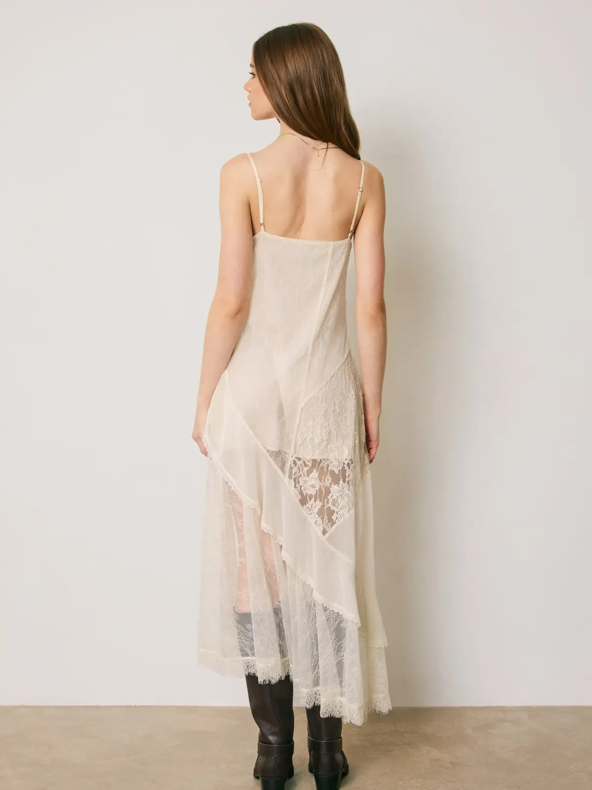 Marielle Lace Tiered Midi Dress featuring delicate floral lace, mixed lace panel detailing, cascading tiered ruffles, and an asymmetrical high-low hemline. Designed with a flattering V-neckline, adjustable spaghetti straps, a scoop back, and a romantic, flowy silhouette.