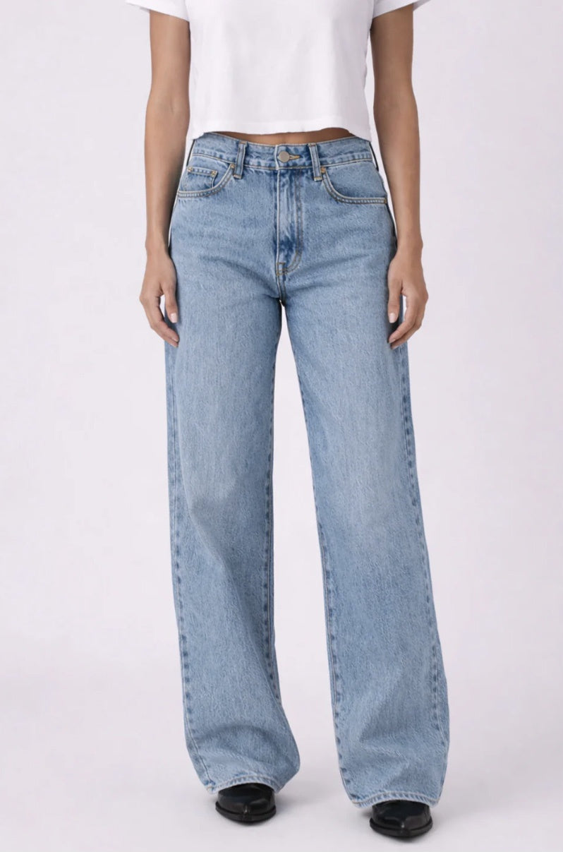 Light blue jeans worn by a person on a white background
