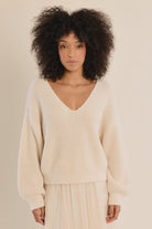 Long-sleeve V-neck sweater featuring a straight fit and delicate lace bow detail at the back.