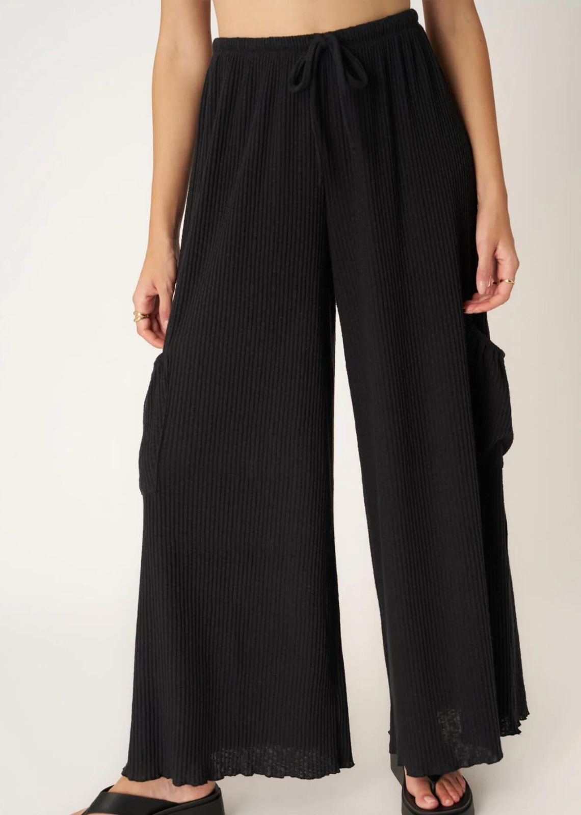 Project Social T Never Better Textured Wide Leg Pant. You'll truly never find a better pant.  Our Never Better Textured Wide Leg Pant features a flowy fit that is perfect for warmer weather. The textured rib fabric perfectly complements the wide leg silhouette. Complete with an elasticized mid waist, functional drawcord, cargo side pockets, and merrow hemline, what more could you ask for in a summer pant?