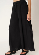 Project Social T Never Better Textured Wide Leg Pant. You'll truly never find a better pant.  Our Never Better Textured Wide Leg Pant features a flowy fit that is perfect for warmer weather. The textured rib fabric perfectly complements the wide leg silhouette. Complete with an elasticized mid waist, functional drawcord, cargo side pockets, and merrow hemline, what more could you ask for in a summer pant?