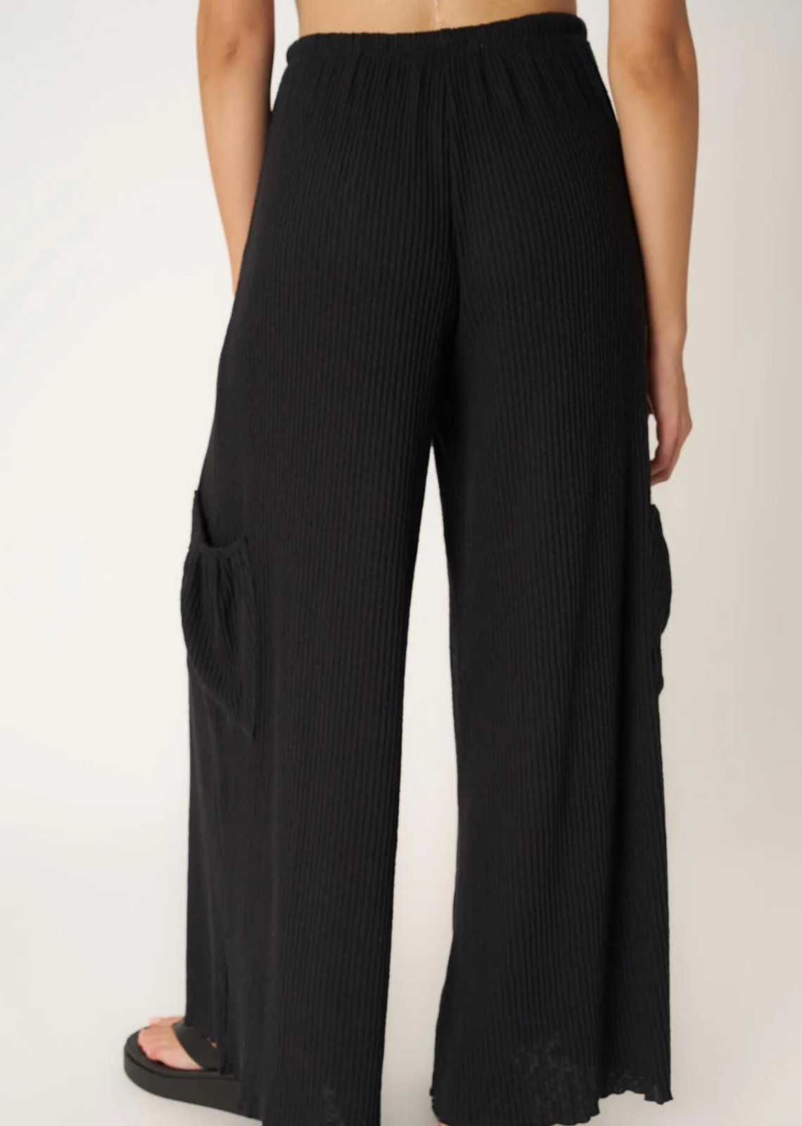 Project Social T Never Better Textured Wide Leg Pant. You'll truly never find a better pant.  Our Never Better Textured Wide Leg Pant features a flowy fit that is perfect for warmer weather. The textured rib fabric perfectly complements the wide leg silhouette. Complete with an elasticized mid waist, functional drawcord, cargo side pockets, and merrow hemline, what more could you ask for in a summer pant?