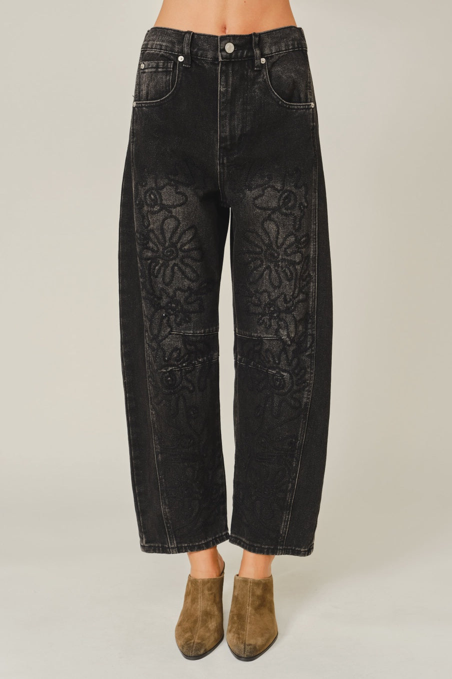 Women’s washed black barrel jeans featuring tonal floral embroidery, high-rise waist, five-pocket styling, relaxed curved leg, and cropped ankle-length fit.