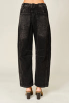 Women’s washed black barrel jeans featuring tonal floral embroidery, high-rise waist, five-pocket styling, relaxed curved leg, and cropped ankle-length fit.