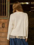 Women’s cream horse knit pullover featuring a relaxed fit, long sleeves, dropped shoulders, and western-inspired horse graphic. Lace under shirt shown is not included.