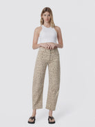 Women’s high-rise barrel jeans in a beige leopard print featuring a relaxed curved-leg fit, five-pocket styling, and cropped ankle length.