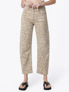 Women’s high-rise barrel jeans in a beige leopard print featuring a relaxed curved-leg fit, five-pocket styling, and cropped ankle length.