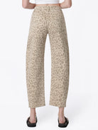 Women’s high-rise barrel jeans in a beige leopard print featuring a relaxed curved-leg fit, five-pocket styling, and cropped ankle length.