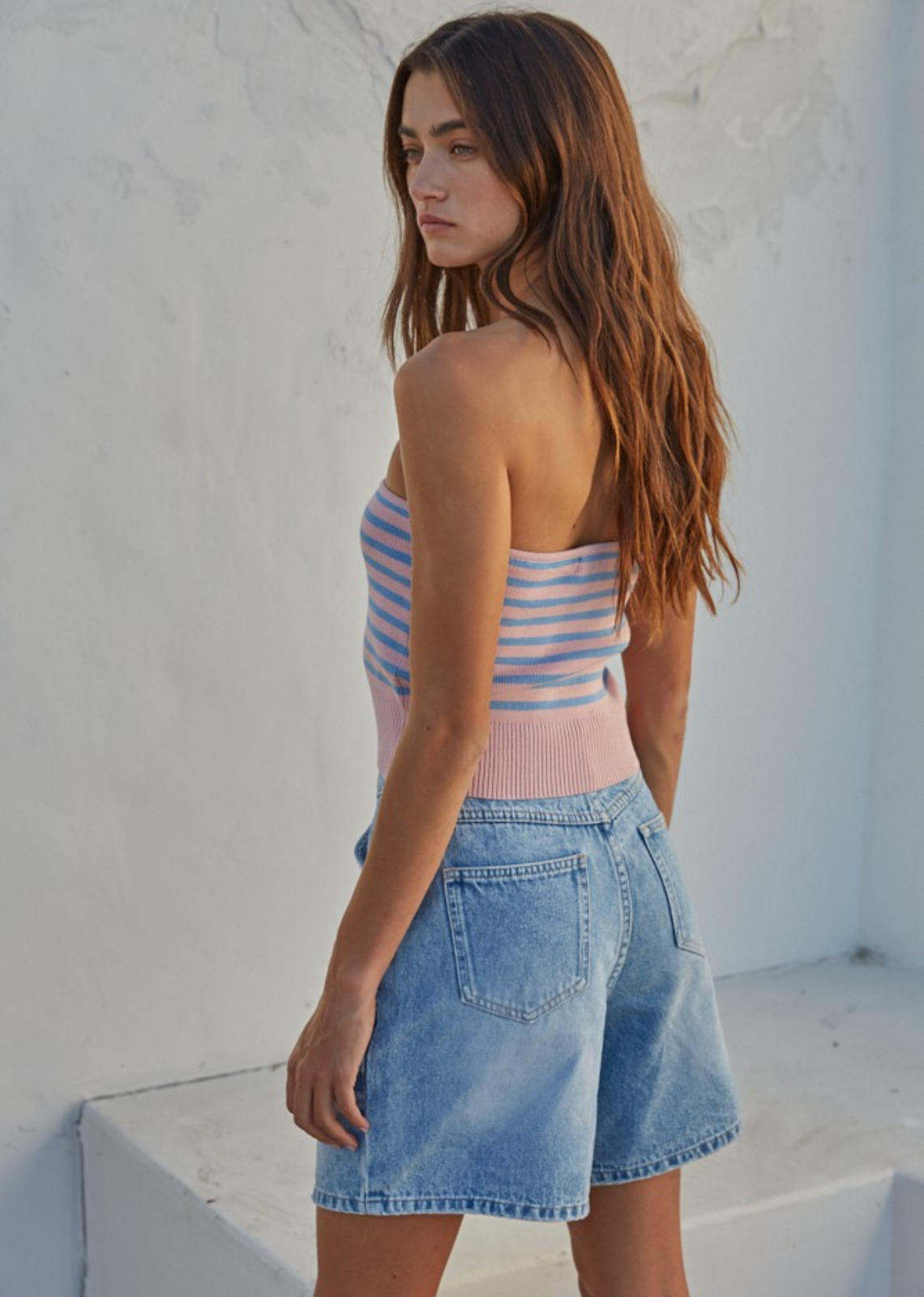 Stacie Tube Top.Elevate your style with this trendy strapless tube top featuring a chic knit ribbed texture and playful stripes in a delightful pink and light blue color combination. Effortlessly fashionable for any occasion.