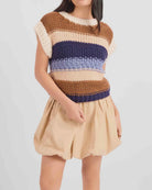 Sleeveless chunky knit top featuring a warm multi-colour stripe pattern, cozy textured finish, and relaxed, slightly boxy fit.