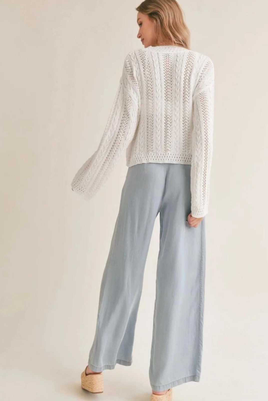Sadie & Sage Ella Cable Knit Sweater. Elevate your spring wardrobe with our Ella Cable Knit Sweater! Featuring a classic cable knit design and lightweight fabric, this long sleeve sweater in white is perfect for layering and keeping you warm without weighing you down.