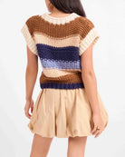 Sleeveless chunky knit top featuring a warm multi-colour stripe pattern, cozy textured finish, and relaxed, slightly boxy fit.