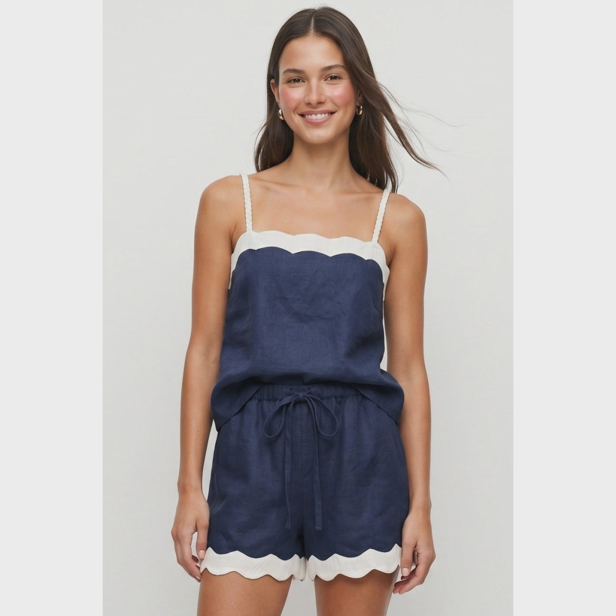 Navy linen-blend tank top featuring a cream scalloped neckline, braided adjustable spaghetti straps, a relaxed fit, and a lightweight woven finish. Designed with a back keyhole and button closure for an elegant summer look.