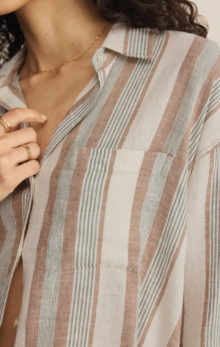 Close-up of a person wearing a striped shirt with a neutral background. Fashion Clothing Store for Women in Hamilton and Burlington Ontario!