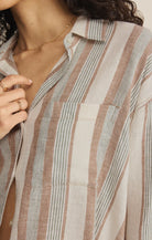 Close-up of a person wearing a striped shirt with a neutral background. Fashion Clothing Store for Women in Hamilton and Burlington Ontario!