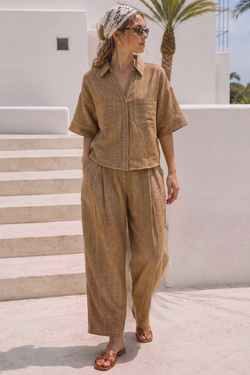 Women's brown linen blend wide leg pants with a relaxed fit, elastic waistband, side pockets, and contrast stitching.