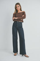 woman wearing dark wash
 high rise wide leg jeans