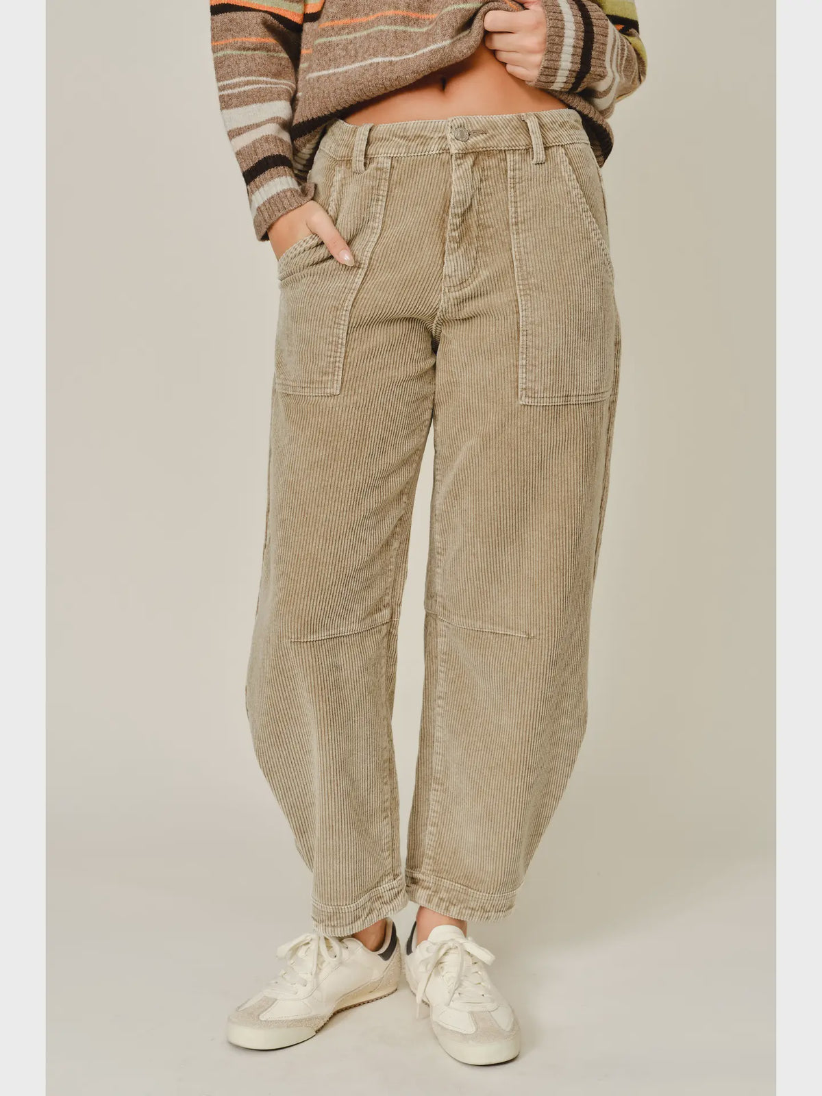 Thea Corduroy Barrel Pants in Taupe featuring a high-rise waist, relaxed barrel-leg silhouette, soft textured corduroy fabric, oversized front patch pockets, subtle seam detailing, and tapered ankle-length hems.