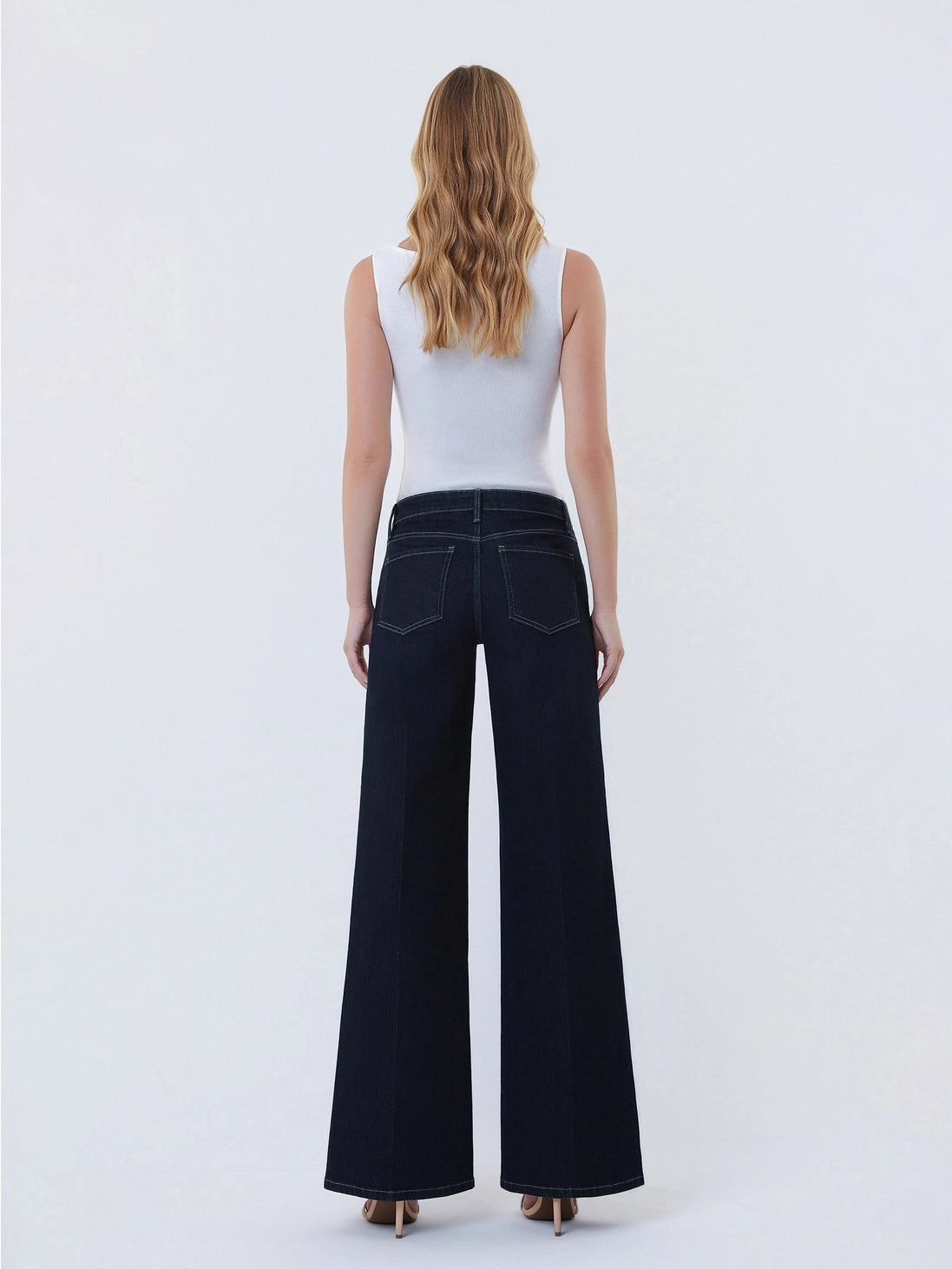 Dark wash wide-leg jeans featuring a mid-rise waist, trouser-inspired front crease, classic five-pocket design, finished hem, and full-length silhouette.