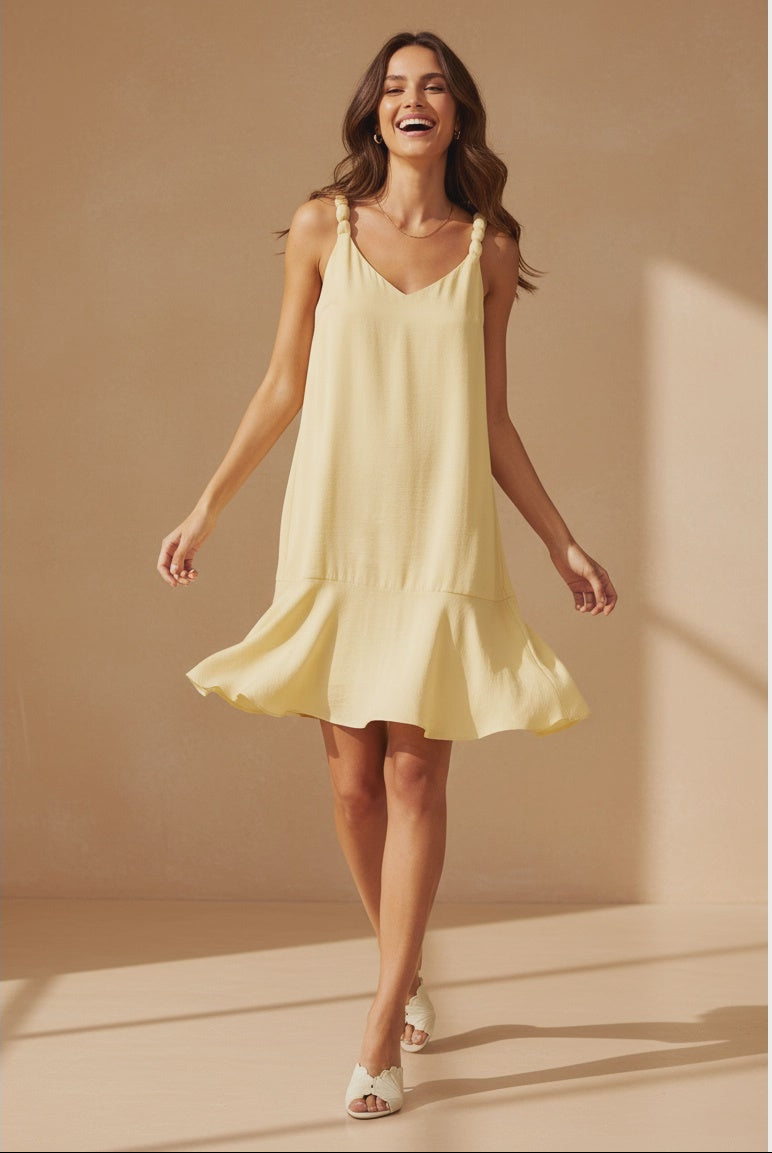 Pale banana sleeveless mini dress featuring a V-neckline, delicate ball-detail shoulder straps, a relaxed A-line silhouette, and a flutter hem