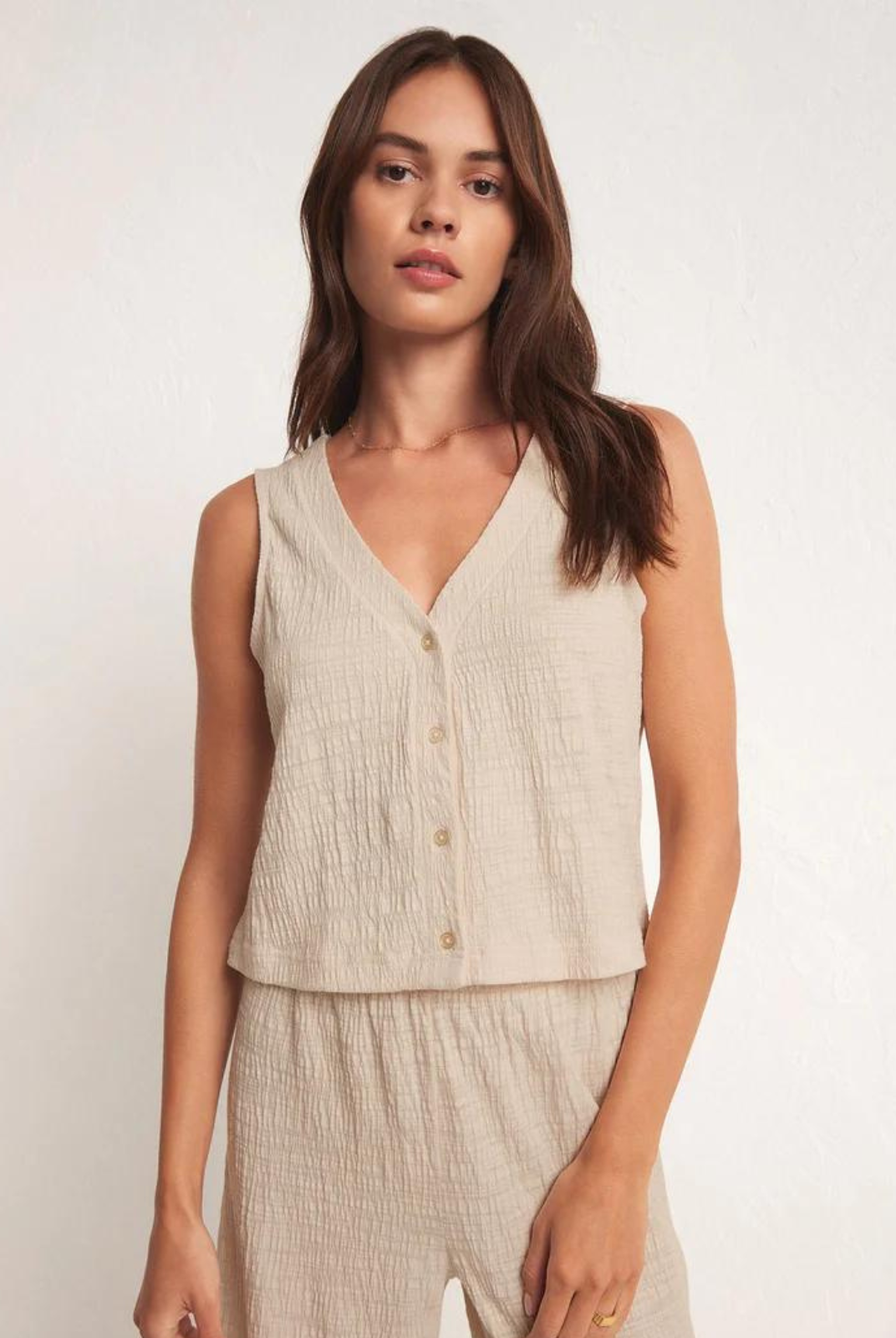 Z Supply Solace Textured Slub Top. When you're looking for a style that can go from professional to picnic in the park. This elevated textured slub button-front top features a sleeveless v-neck design and flattering relaxed fit.