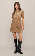 Faux suede mini shift dress featuring a collared neckline, short sleeves, front snap-button closures, chest and front patch pockets, and a relaxed fit.