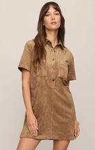 Faux suede mini shift dress featuring a collared neckline, short sleeves, front snap-button closures, chest and front patch pockets, and a relaxed fit.