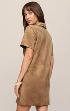 Faux suede mini shift dress featuring a collared neckline, short sleeves, front snap-button closures, chest and front patch pockets, and a relaxed fit.