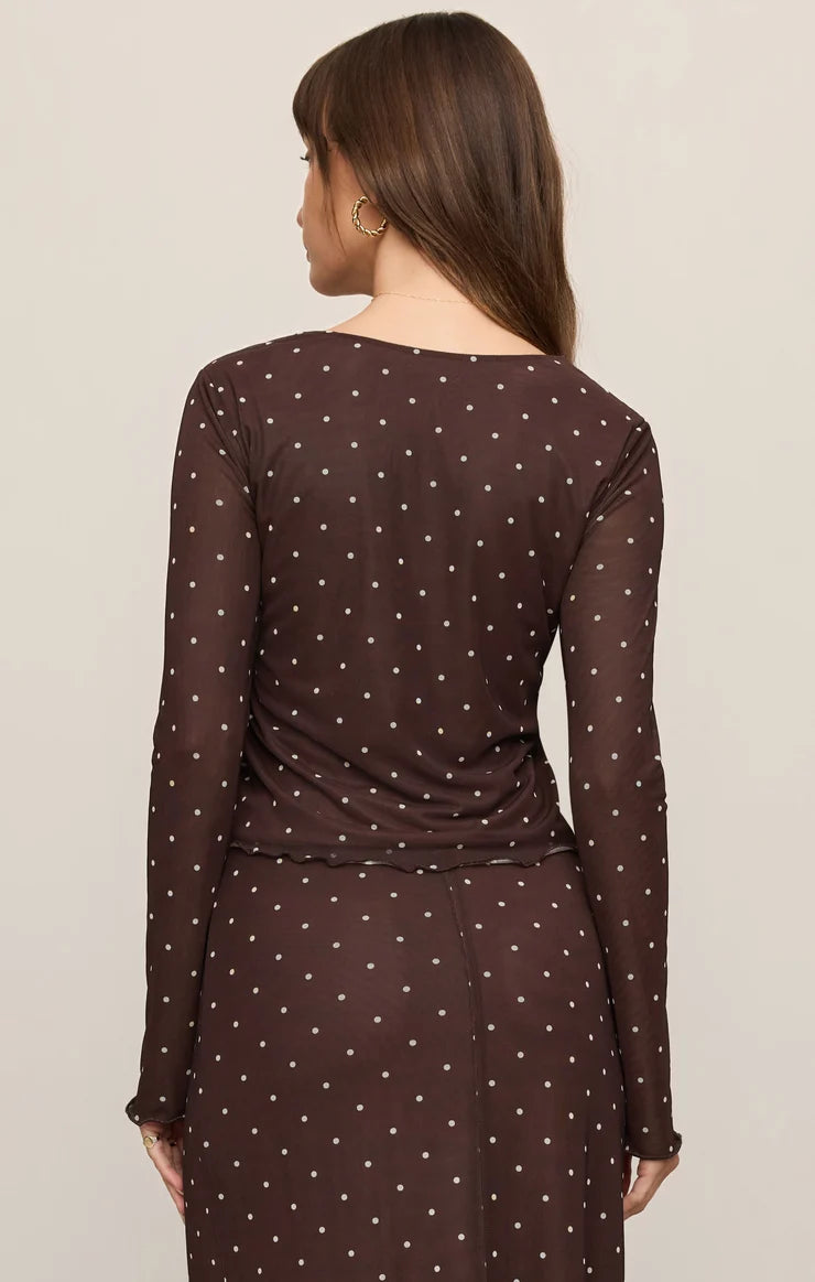 Brown mesh long-sleeve top with white polka dots, featuring a V-neckline, delicate front ties, and a slightly sheer fitted design.

