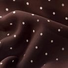 Brown mesh midi skirt with white polka dots, featuring a high-rise elastic waistband, lettuce-edge hem, and fully lined silhouette.
