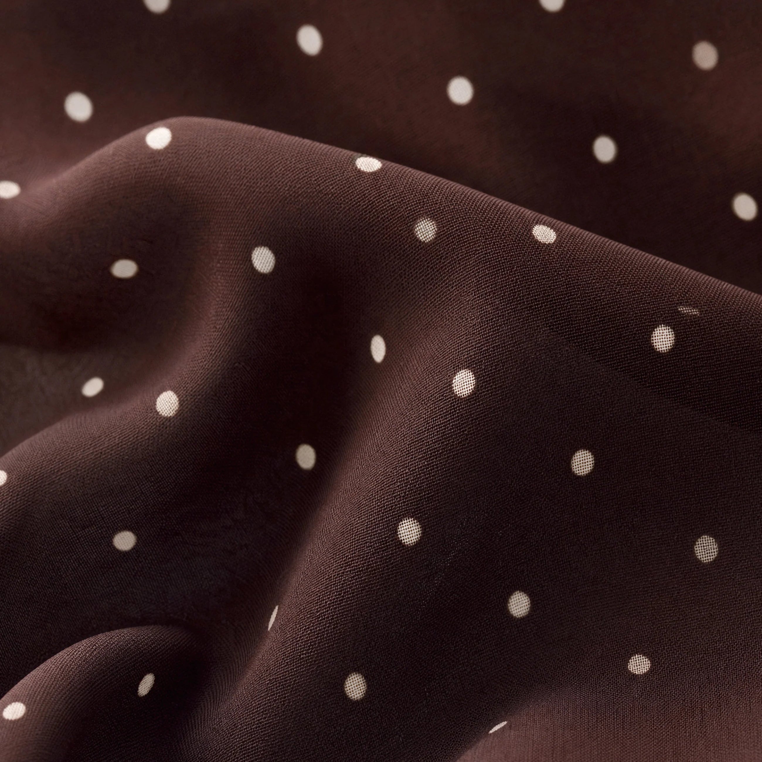 Brown mesh midi skirt with white polka dots, featuring a high-rise elastic waistband, lettuce-edge hem, and fully lined silhouette.
