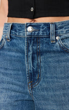 High-rise wide-leg jeans in a vintage-inspired blue wash, featuring a subtle twisted seam, full-length legs, and classic five-pocket styling.
