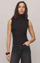 Close-fitting high-neck tank top in soft, stretchy baby rib fabric with subtle side ruching for a flattering, sculpted silhouette. A sleek, fitted essential that's perfect for layering or wearing on its own.