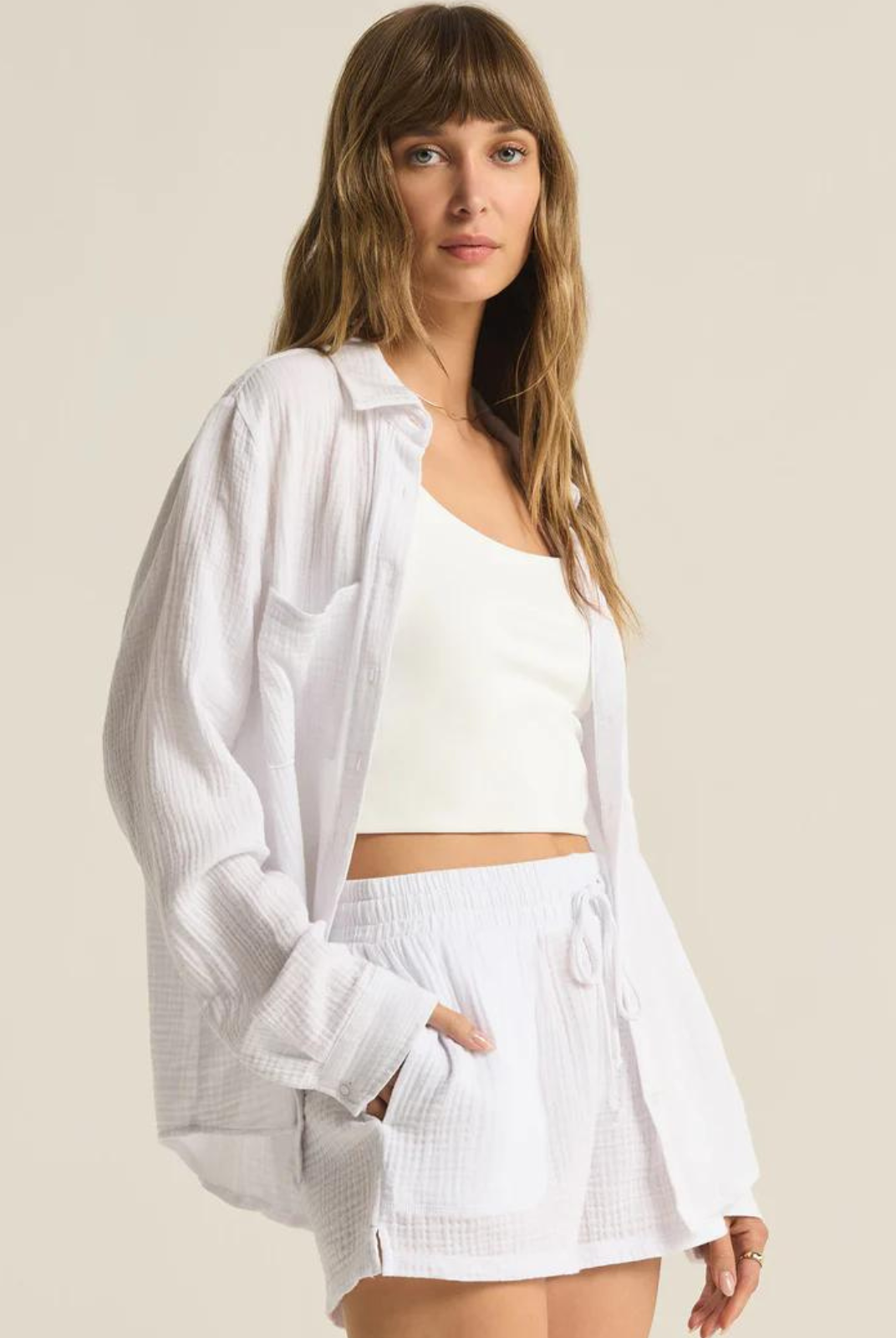 Z Supply Kaili Button Up Gauze Top- White. Meet the dressier side of gauze. This button up gauze top can be worn day to night, and features a relaxed fit with front pockets.
