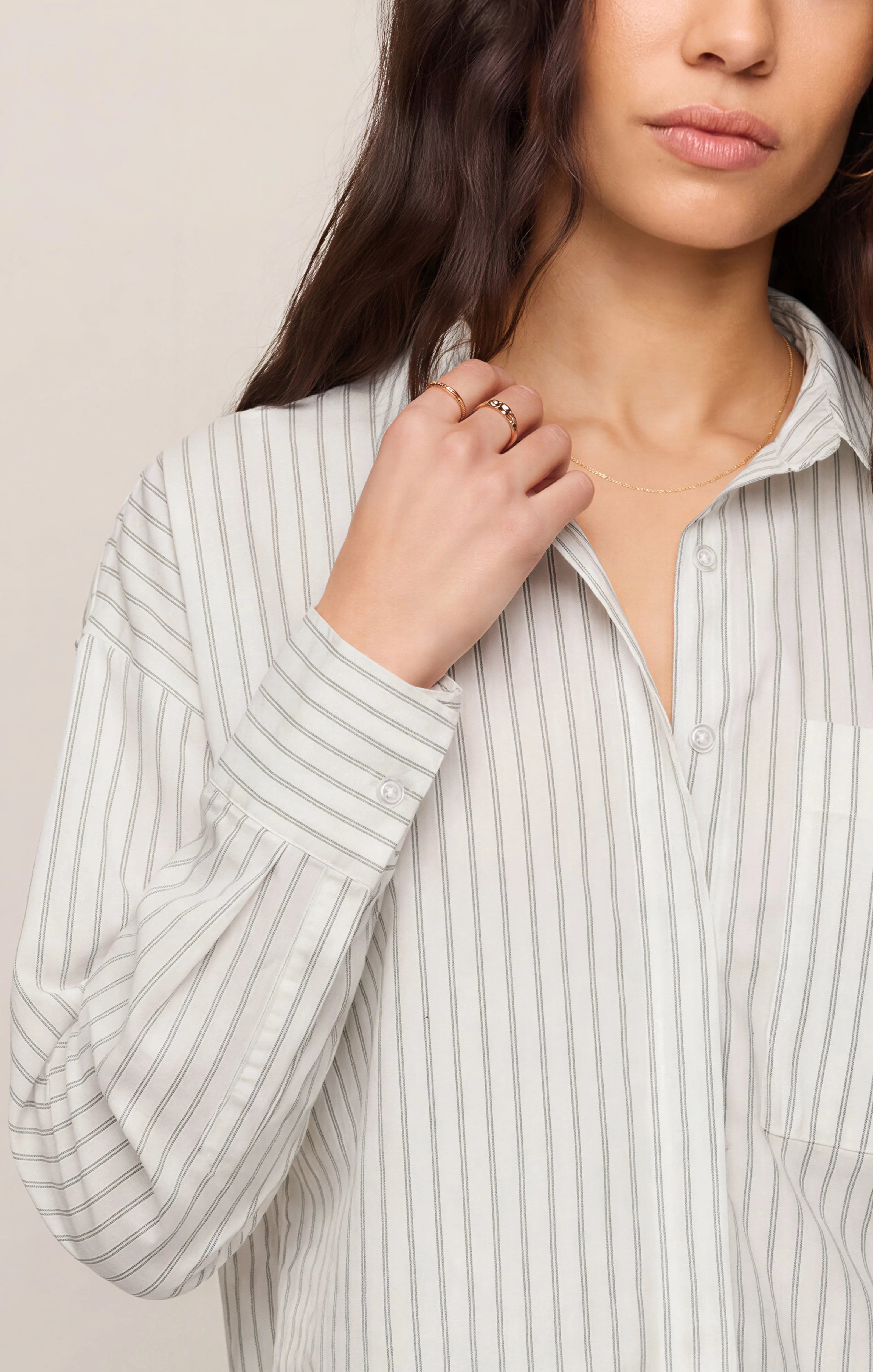 Striped long-sleeve button-up shirt in lightweight cotton poplin with a classic collar, chest pocket, and structured silhouette. Designed with a slightly shorter length for a modern fit, this polished everyday essential features a timeless striped pattern and crisp cotton fabrication.
