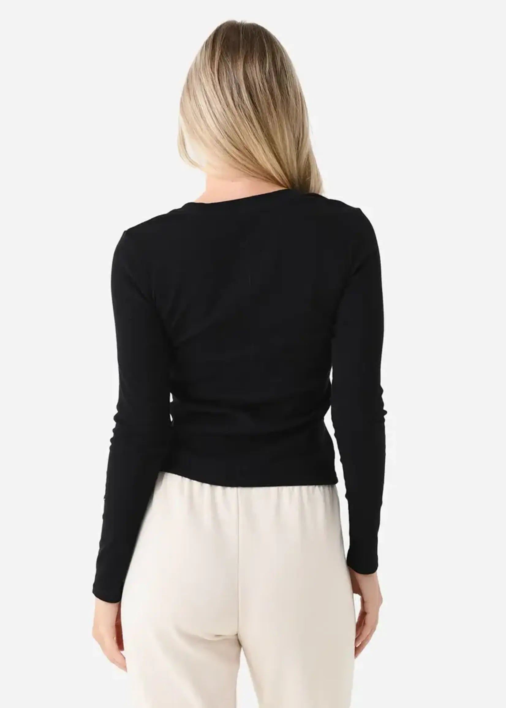 Model wearing the Z Supply Greyson Scoop Long Sleeve featuring a fitted rib knit design with a scoop neckline and long sleeves