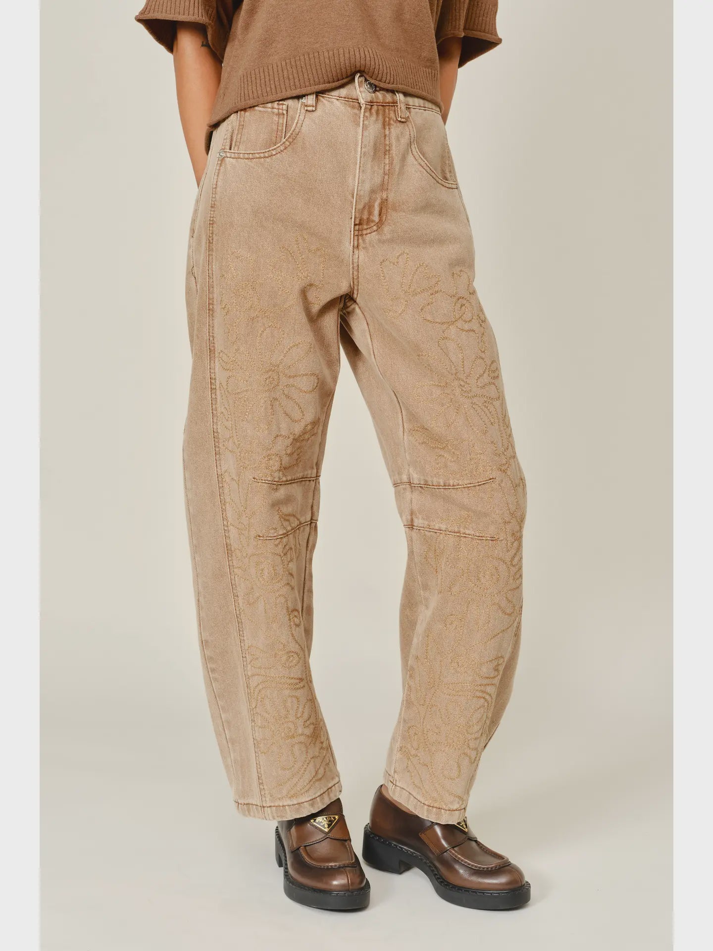 The Ophelia Embroidered Barrel Jeans in rust, featuring tonal floral embroidery, a relaxed barrel-leg silhouette, and a cropped ankle-length fit.
