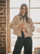 Women’s dove bomber jacket featuring a relaxed fit, zip-front closure, voluminous long sleeves, side pockets, and gathered hem detailing.