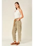 Women’s camel corduroy trousers featuring a subtle barrel fit, utility patch pockets, belt loops, and a rope tie waist.