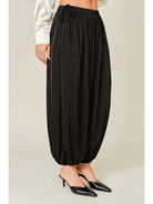 Zola Striped Satin Bubble Pants featuring a soft, glossy satin finish with a striped pattern, comfortable elastic waistband, adjustable drawstring side details, and functional side pockets. Designed with a relaxed, voluminous balloon silhouette and a flowy, lightweight feel for an effortlessly chic look.
