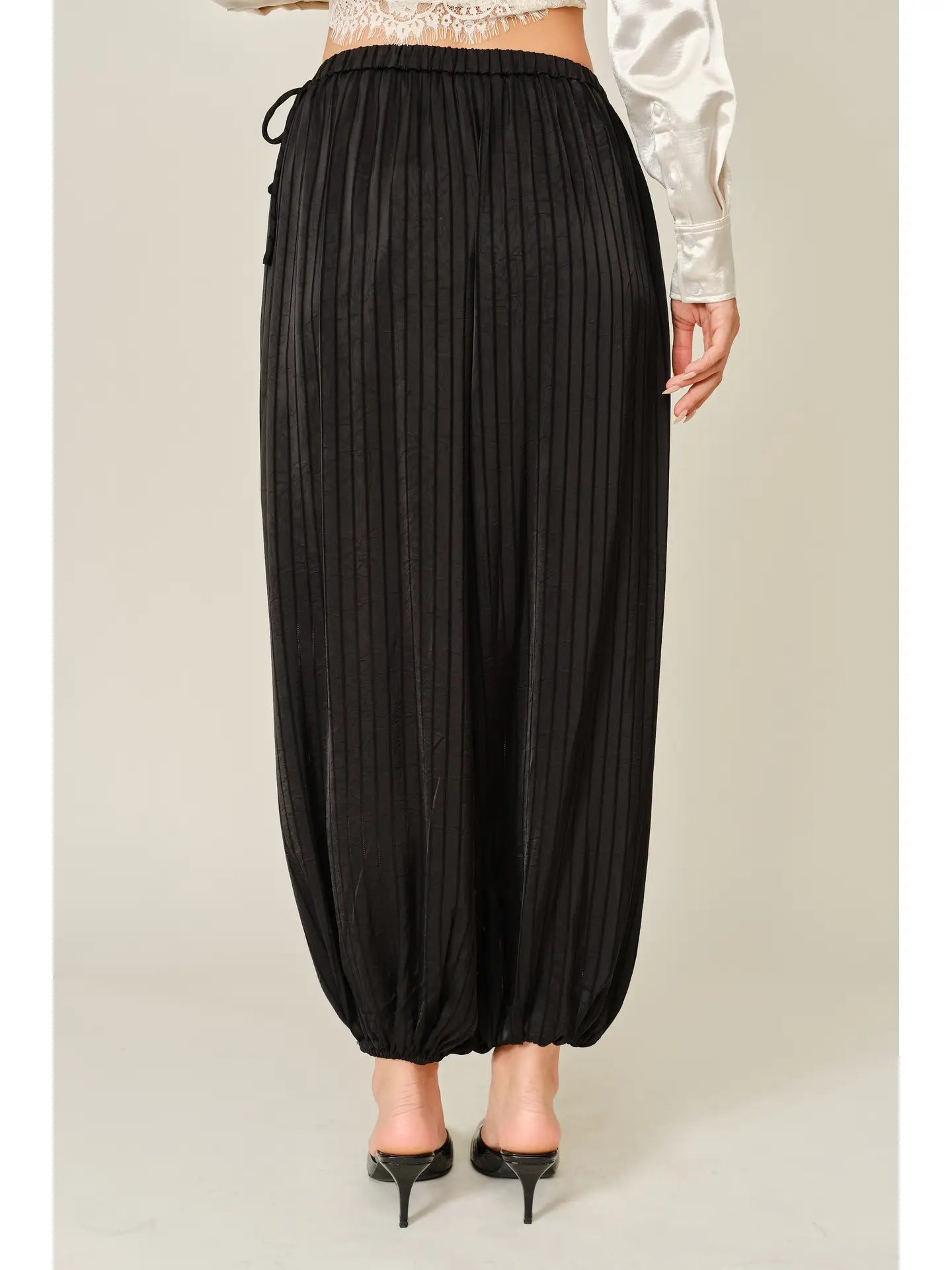 Zola Striped Satin Bubble Pants featuring a soft, glossy satin finish with a striped pattern, comfortable elastic waistband, adjustable drawstring side details, and functional side pockets. Designed with a relaxed, voluminous balloon silhouette and a flowy, lightweight feel for an effortlessly chic look.